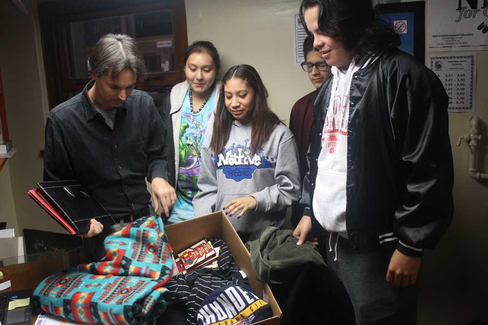 N.I.C.E. Instructor Harmon Maples works with students to pack up donations for protesters in North Dakota. Many are protesting the building of an oil pipeline.