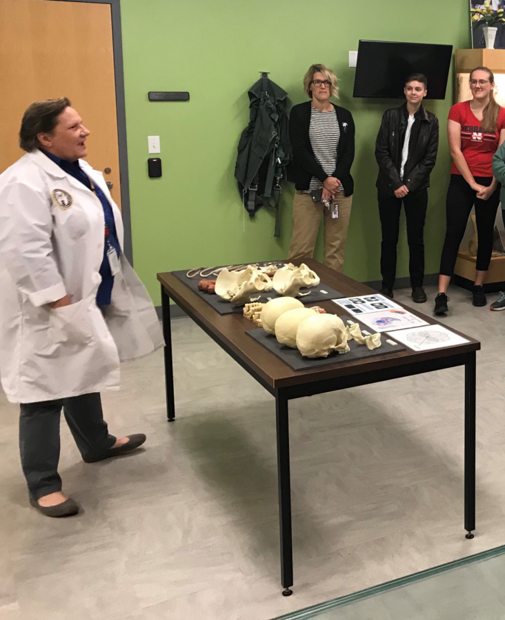 Librarian, Colleen Nieland, and AP students Luka Morris and Natalie Ruckman listen intently as Dr. Penny Minturn answers their questions.