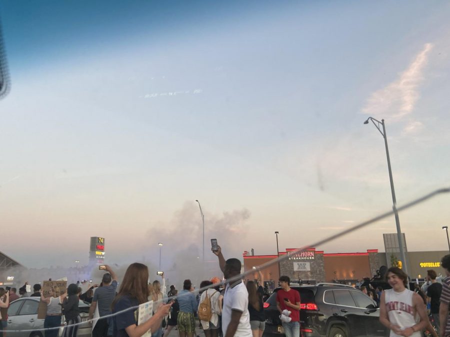 Young man takes a picture of 72nd street seconds after the first tear gas explosion