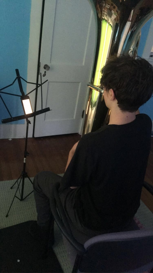 Junior Liam Maher practices the tuba at home during remote learning.