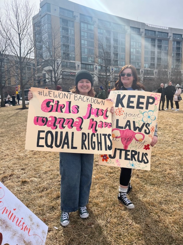 Girl+Up+members+hold+signs+at+Omahas+Womens+Day+March+in+Turner+Park.+Hundreds+in+the+community+gathered+this+day+to+voice+their+support+for+womens+rights.