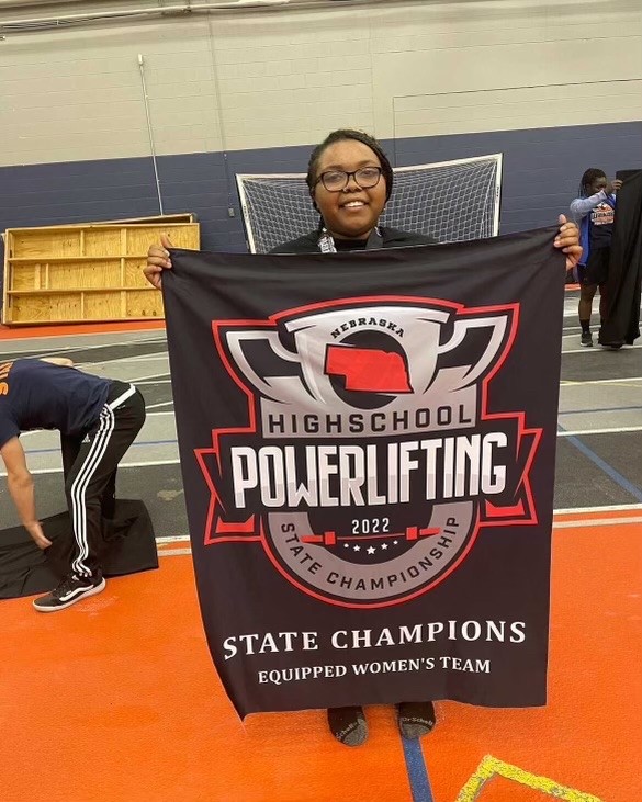 Sophomore+Keijha+Hadley+poses+with+her+state+championship+banner