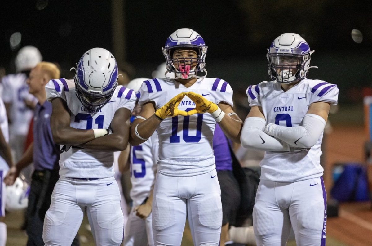 Bryce Lytle (12), Alijah Wayne (11), and Ike Ackerman (11) posing at the game at Lincoln High