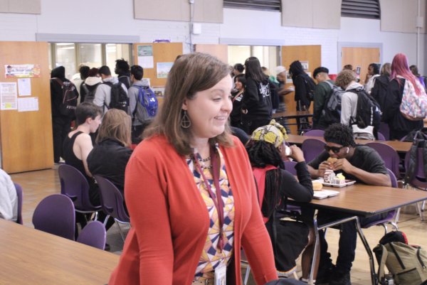 Assistant Principal, Ms. Ellis discussing the best fries in Omaha with students in the cafeteria.