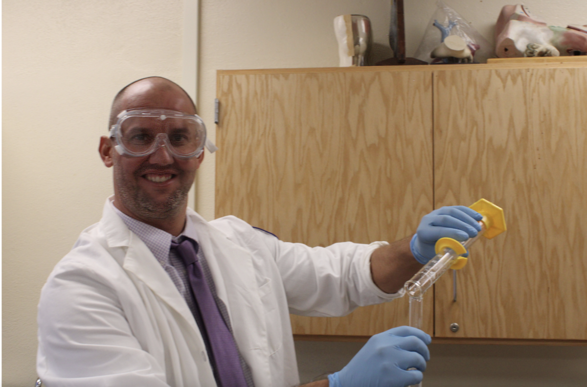 Mr. Berzins pours a mixture of liquids and carbohydrates into a vial for a lab in room 341 on Sept 26