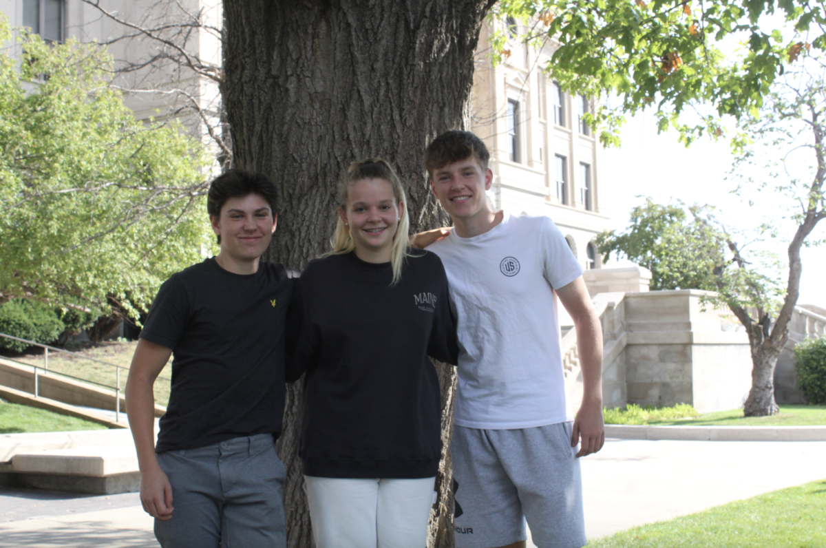 CJ Magnusson, Zita Eyskens, Valentin Leigtner (12) stand infront of Central 