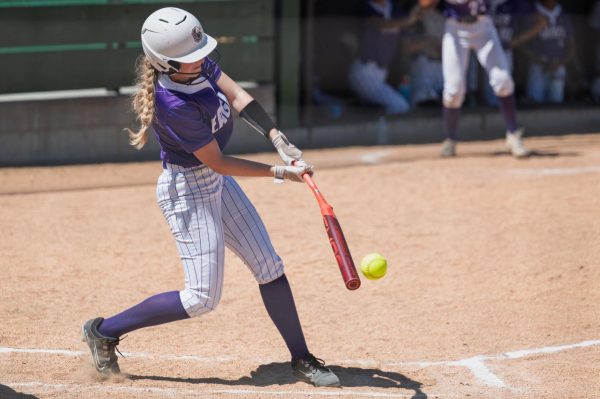 Senior Edie Tidus swings and hits the ball versus Lincoln Northeast