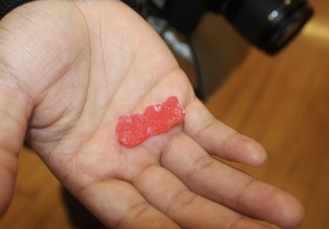 Chrishyra Marion, Junior, holds a sour candy made with Red 40 dye.