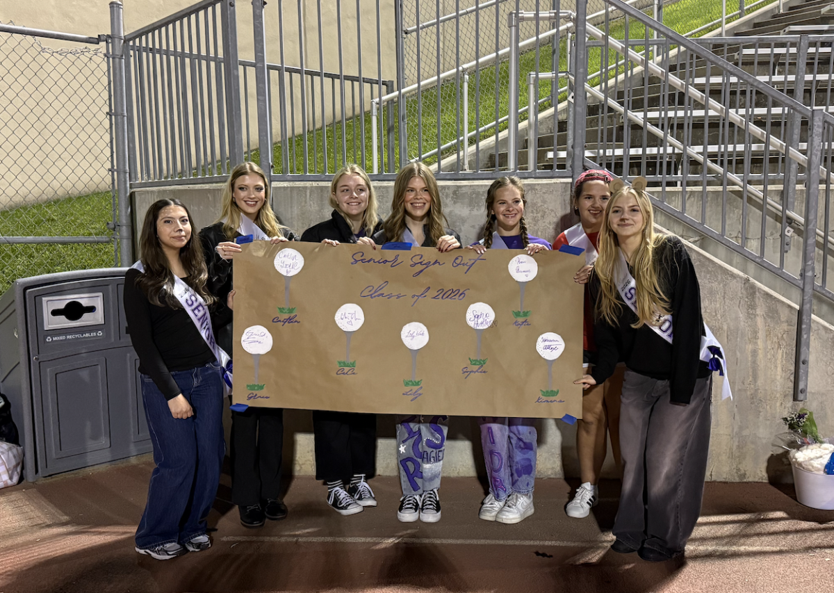 Girls golf seniors gather at senior night after signing out at senior night.