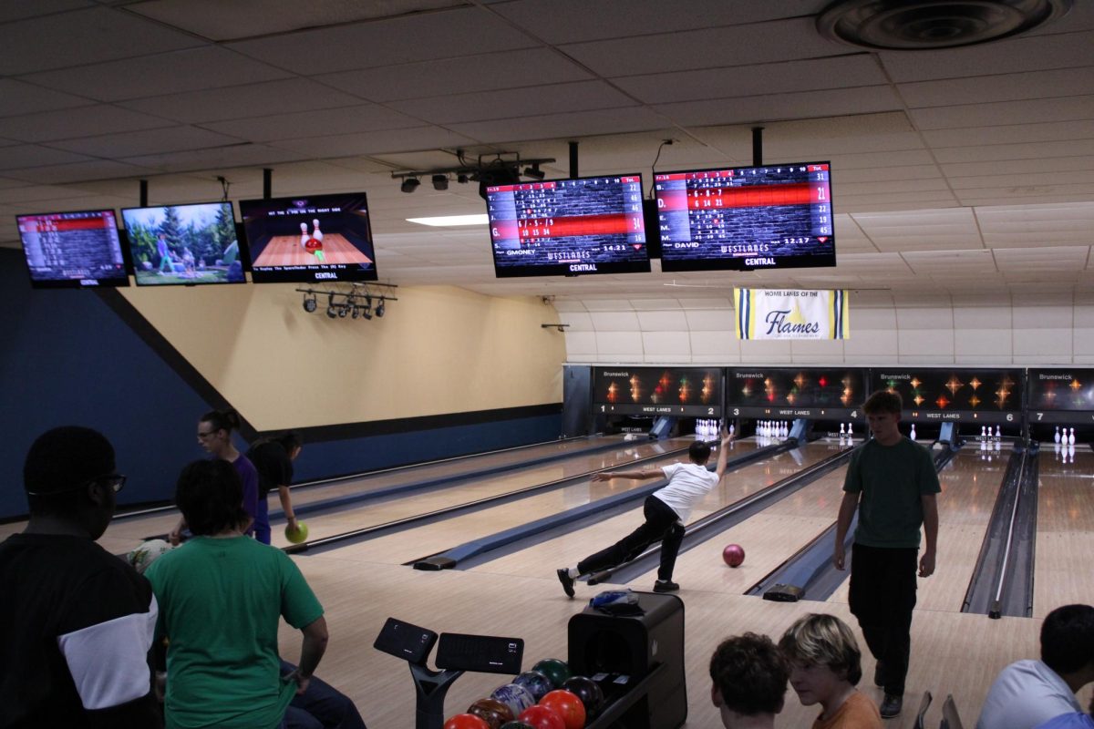 Students bowling while others watch or get ready for their next play at West Lanes.