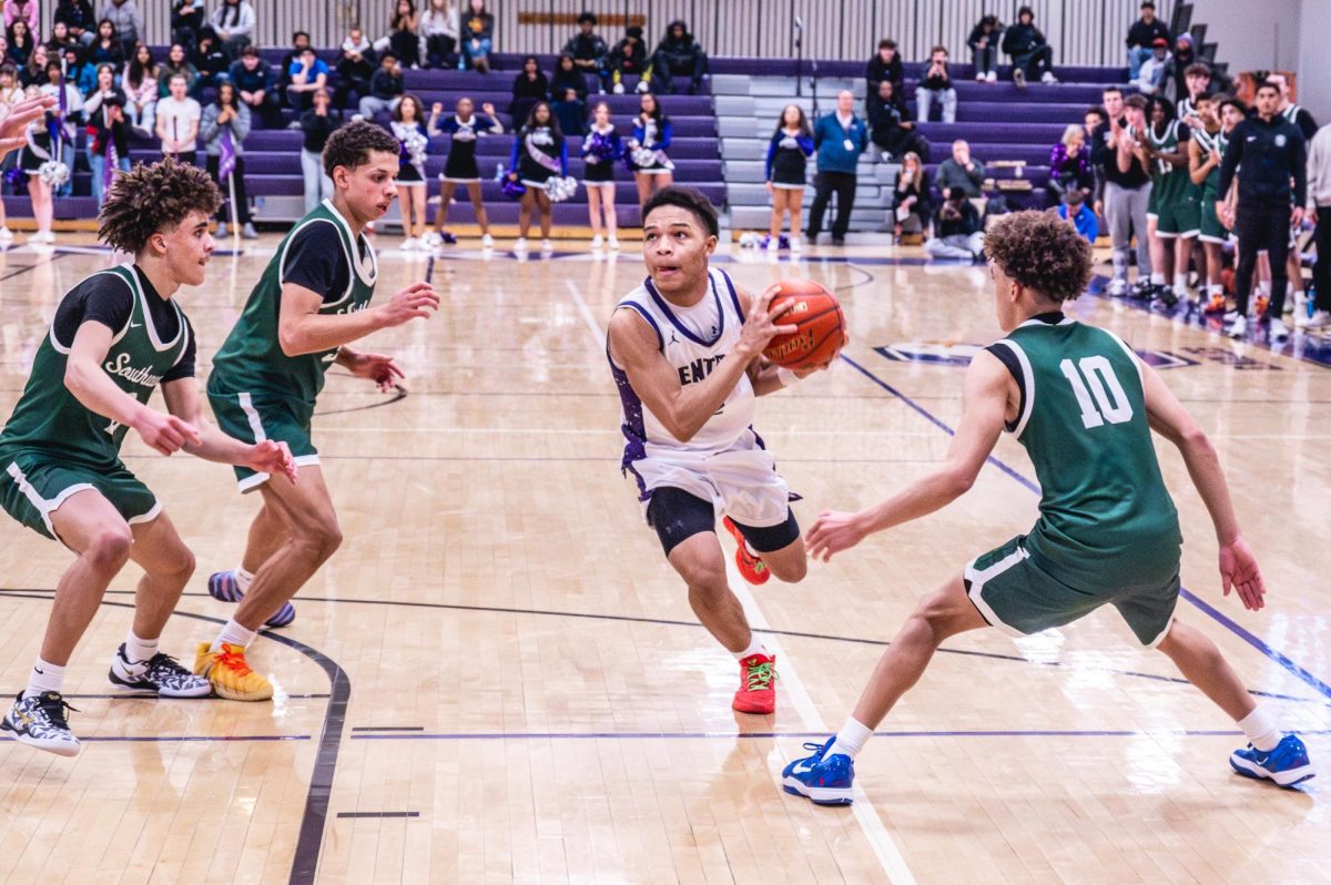 Sophomore Yasir Grixby works his way towards the net to score game winning shot versus Lincoln Southwest on Feb. 23.