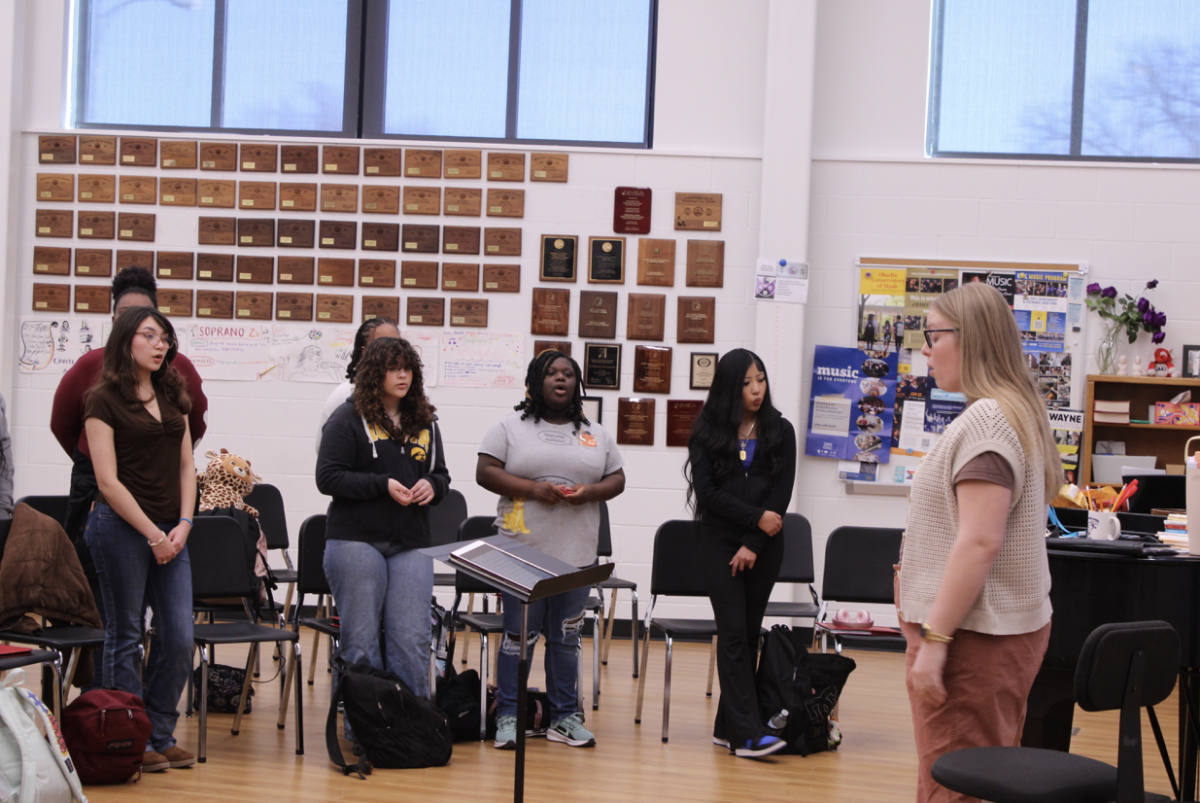 Choir students sing as teacher Catherine Bohn teaches