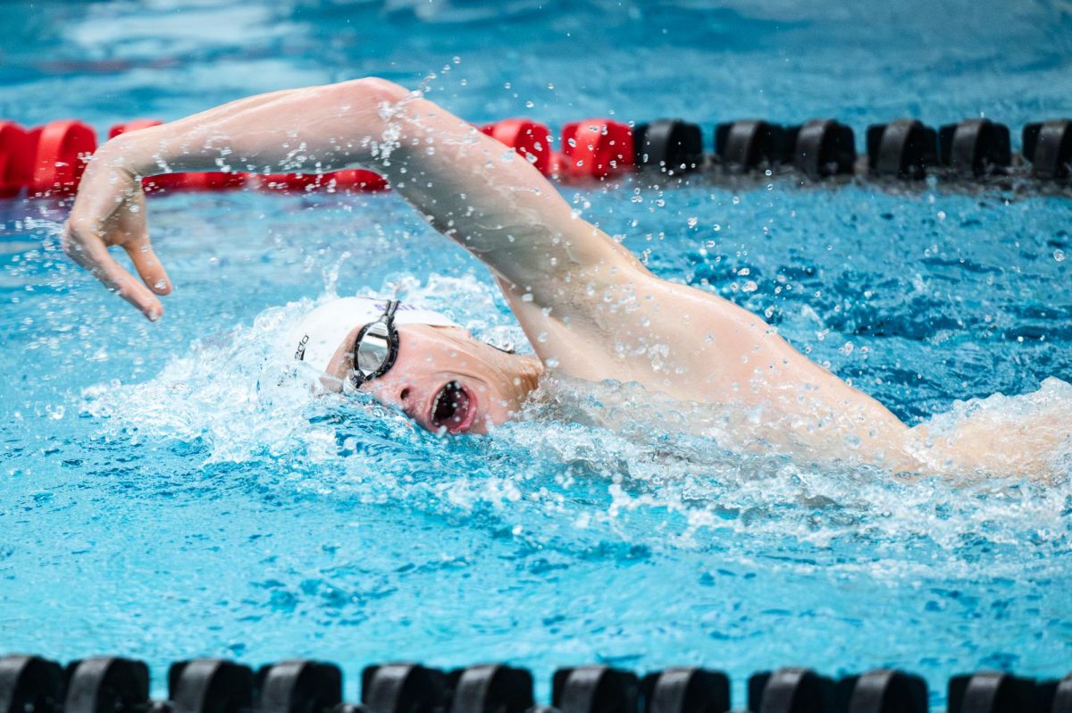 Senior Carter Hiley gasps for air at a swim meet Jan. 8 at Norris Middle School 
