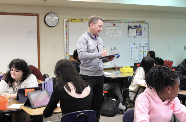 Math teacher Mr.Larson teaching a class of sophomores in room 440.